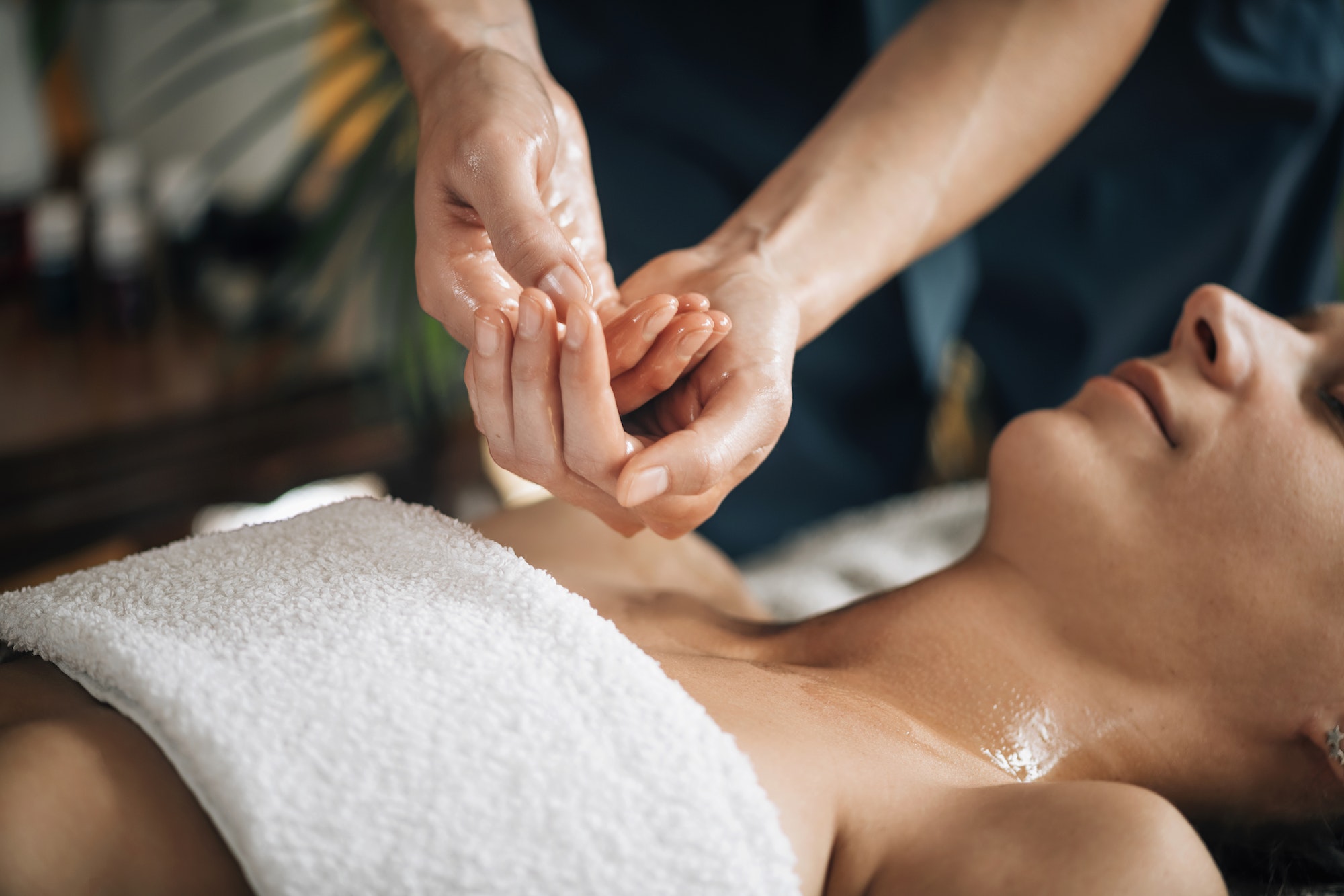 Ayurvedic Aromatherapy Oil Massage. Masseuse Holding Ayurveda Oil for Body Massage